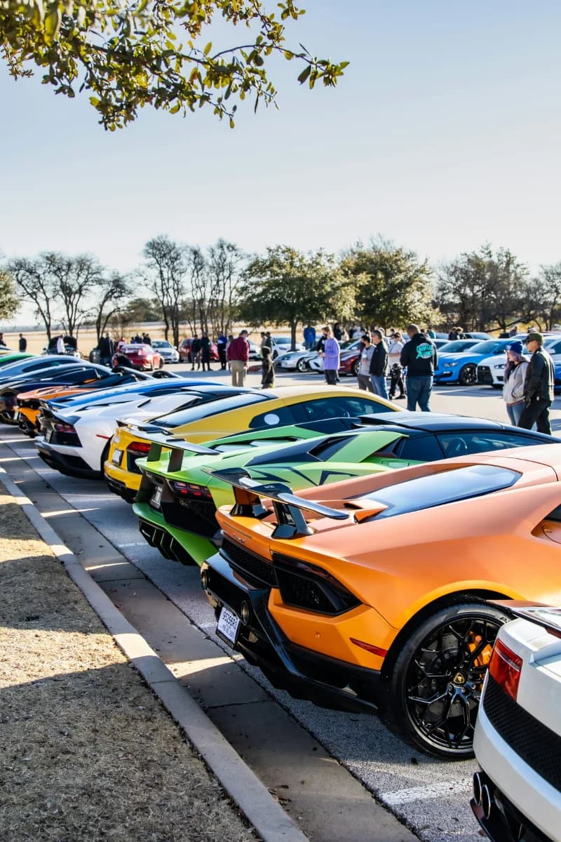 Supercars and enthusiasts gathered at an automotive event